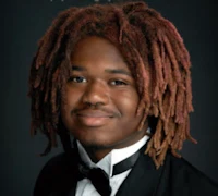 a young man with dreadlocks in a tuxedo